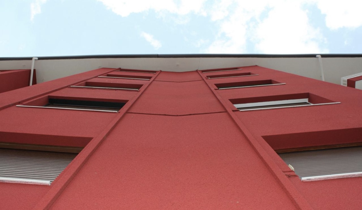 Red spray cork facade on a multi-storey building